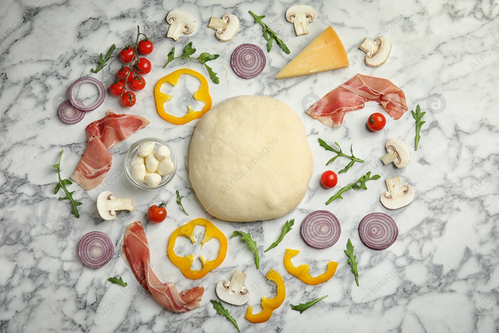 Photo of Flat lay composition with dough and fresh ingredients for pizza on white marble table