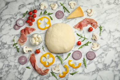 Photo of Flat lay composition with dough and fresh ingredients for pizza on white marble table
