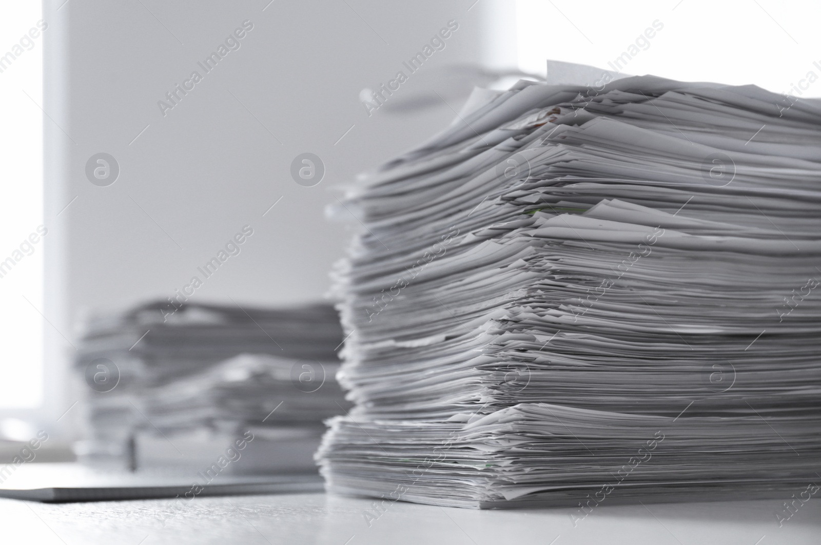 Photo of Stacks of documents on desk in office