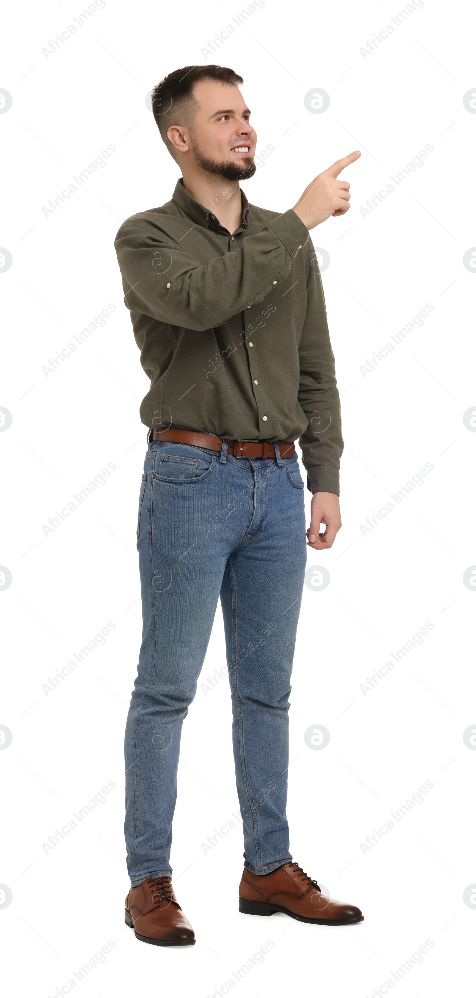 Photo of Man in shirt and jeans pointing at something on white background