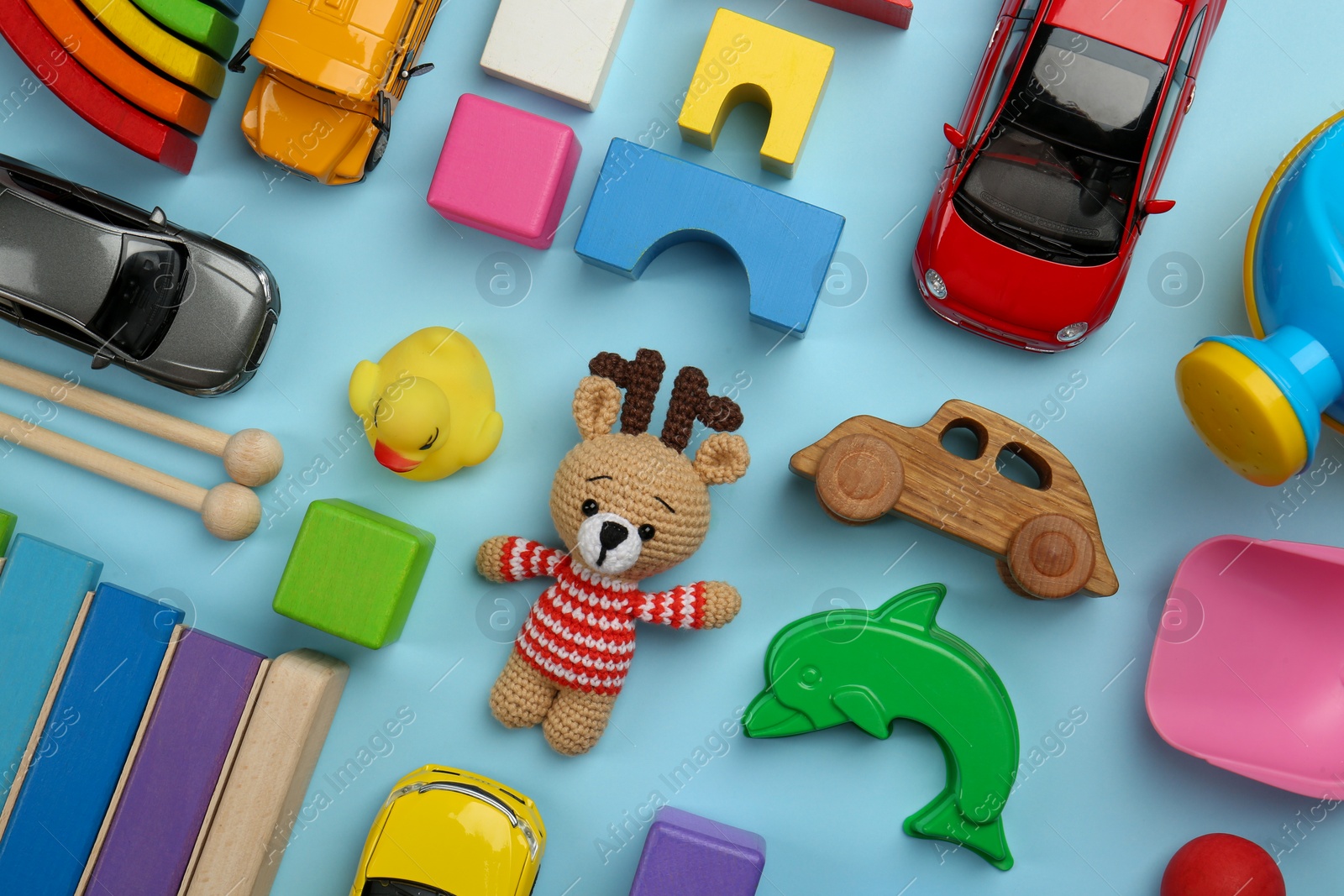 Photo of Different children's toys on light blue background, flat lay