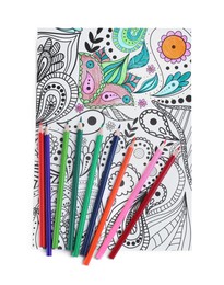 Photo of Antistress coloring page and pencils on white background, top view
