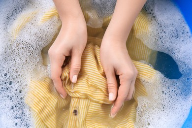 Photo of Woman washing garment in suds, closeup. Laundry