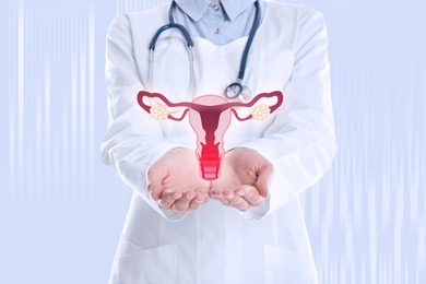 Image of Doctor demonstrating virtual image of inflamed female reproductive system on light background, closeup. Vaginal candidiasis