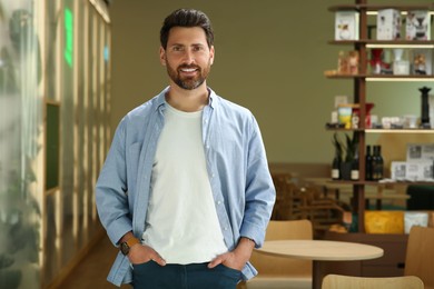 Photo of Portrait of handsome stylish man in cafe