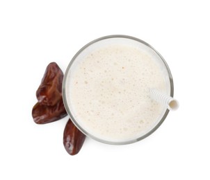 Glass of delicious smoothie and dried dates on white background, top view