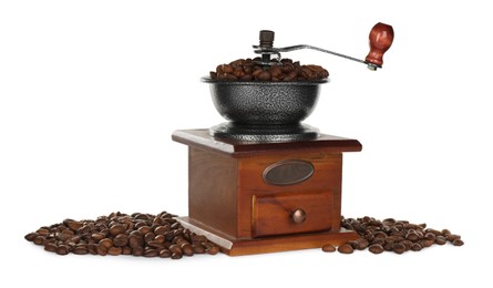 Vintage manual coffee grinder with beans on white background