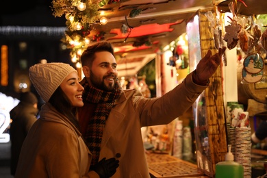 Photo of Lovely couple spending time together at Christmas fair