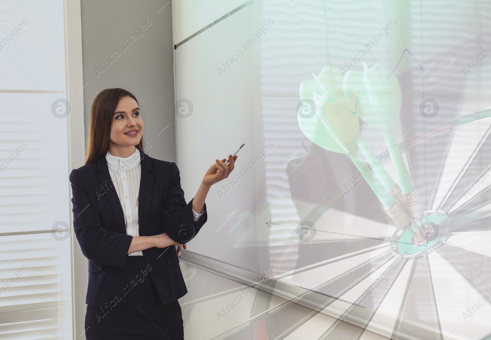 Image of Young businesswoman in office and dart board with arrows. Double exposure 