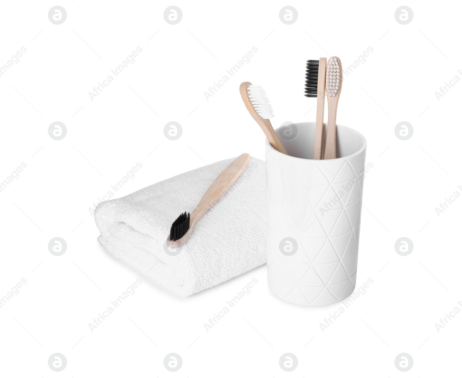 Photo of Bamboo toothbrushes and towel isolated on white