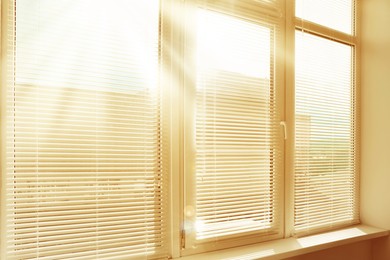 Image of Stylish window with horizontal blinds in room