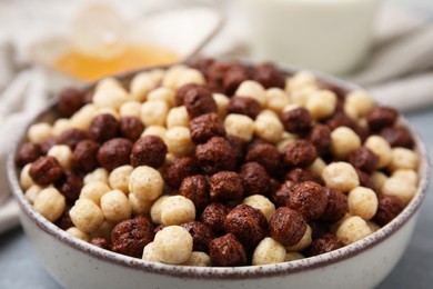 Photo of Tasty cereal balls in bowl on table, closeup