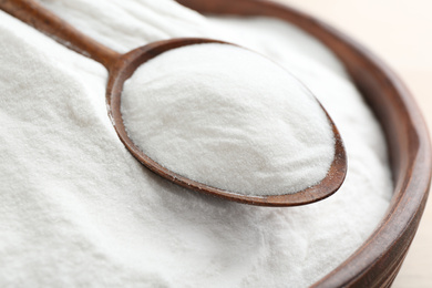 Bowl and spoon with baking soda, closeup