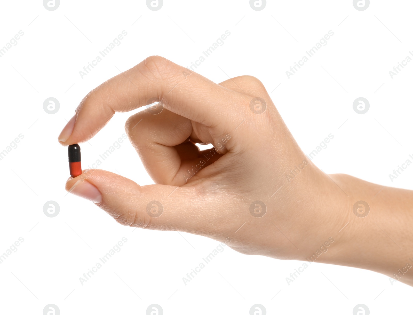 Photo of Woman holding color pill on white background, closeup