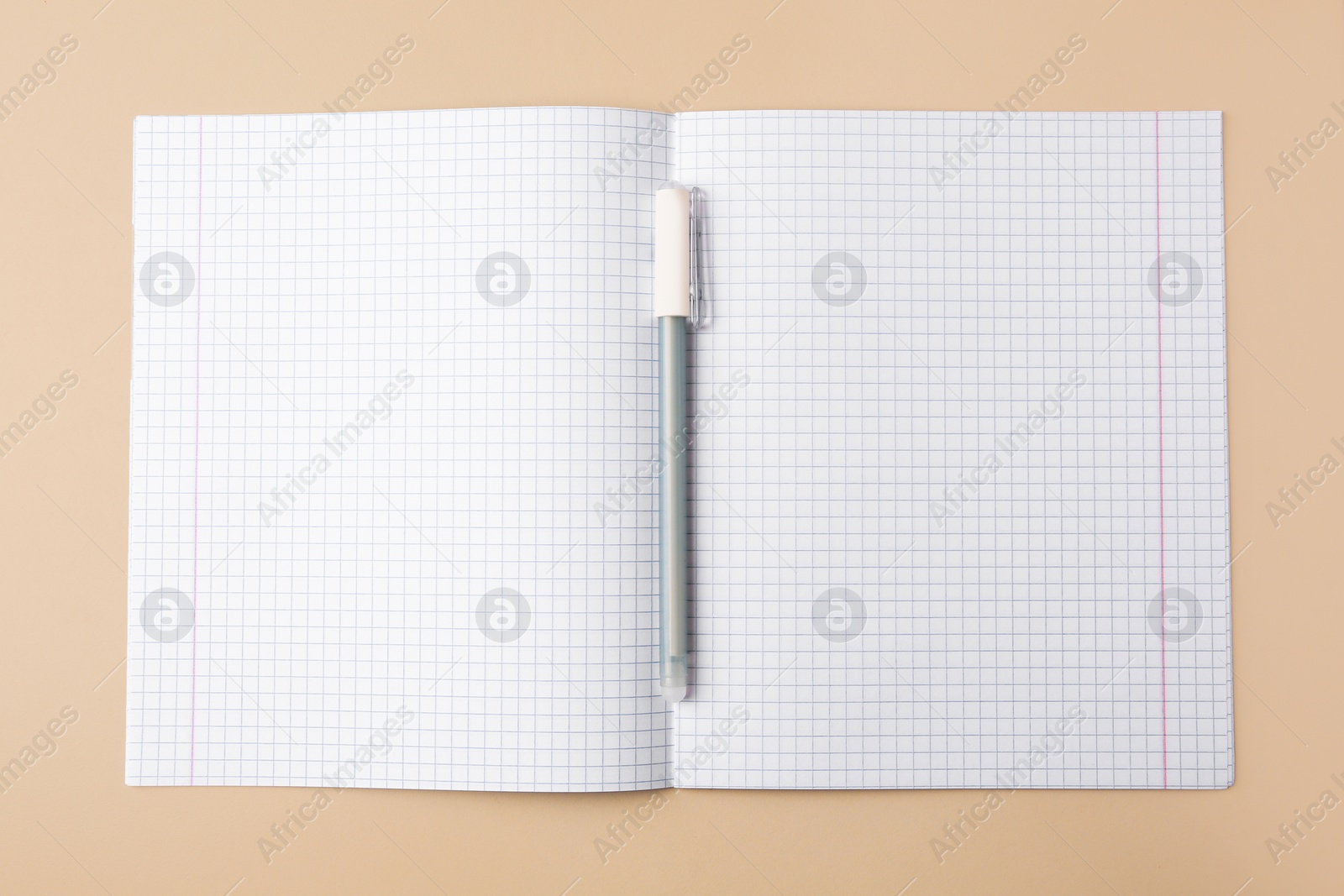 Photo of Copybook with erasable pen on beige background, top view