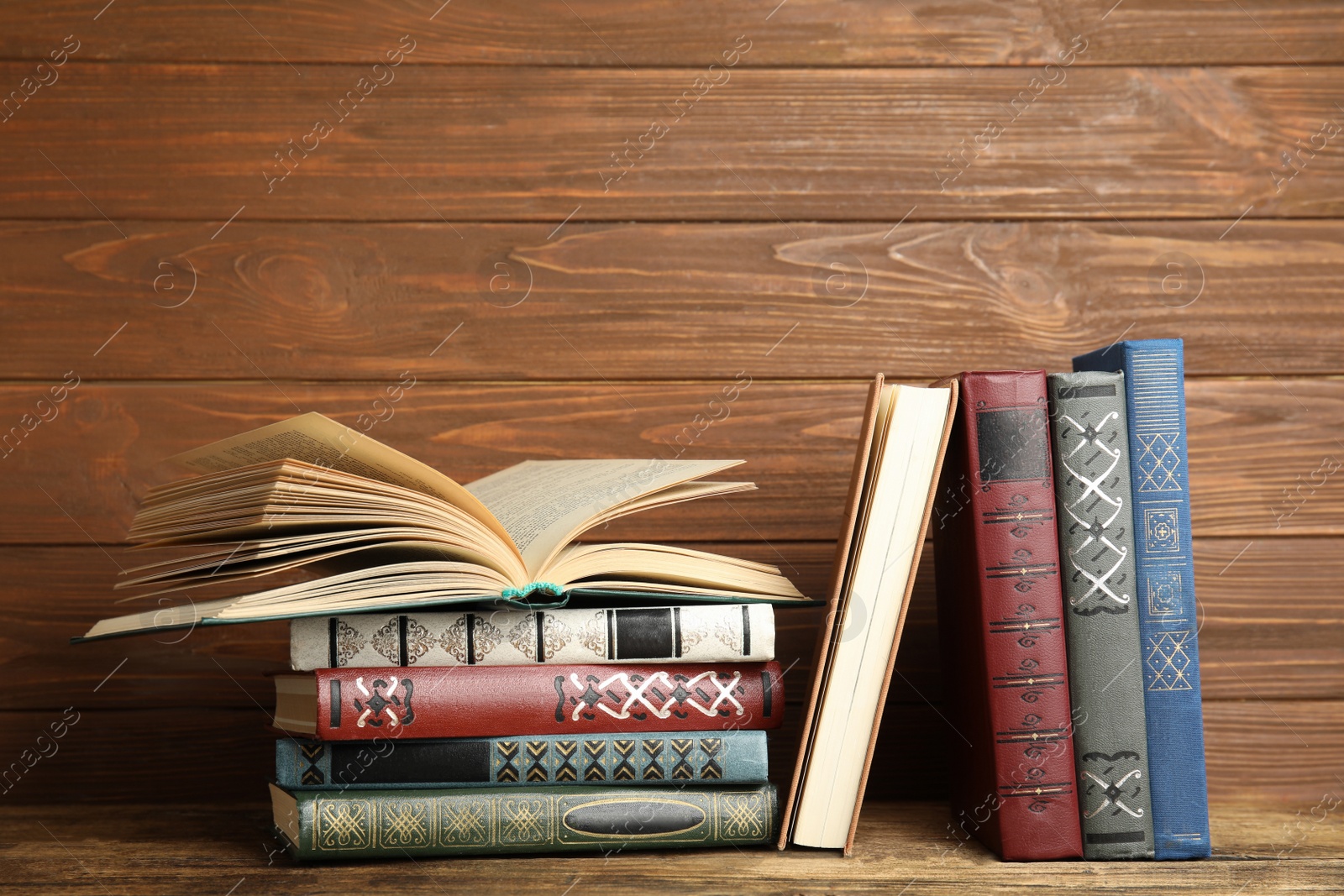 Photo of Collection of old books on wooden shelf