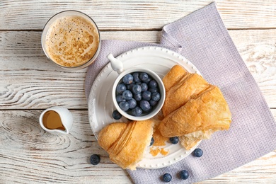 Tasty croissant with berries served for breakfast on plate