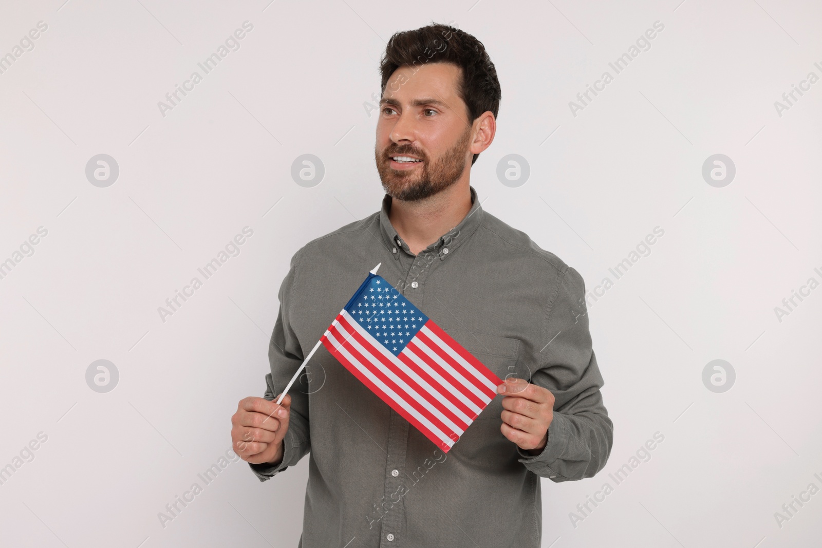 Photo of 4th of July - Independence Day of USA. Happy man with American flag on white background