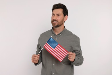 4th of July - Independence Day of USA. Happy man with American flag on white background
