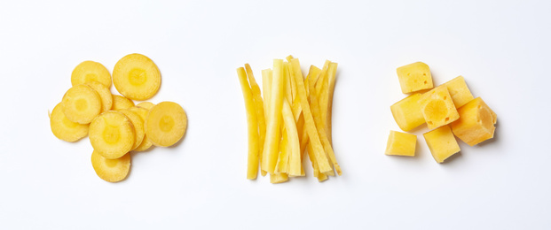 Photo of Cut raw yellow carrot on white background, top view