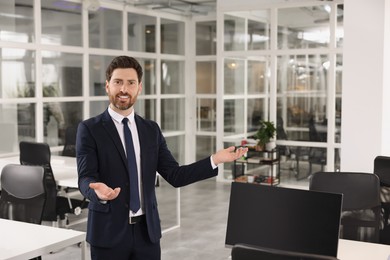 Photo of Confident male real estate agent in office