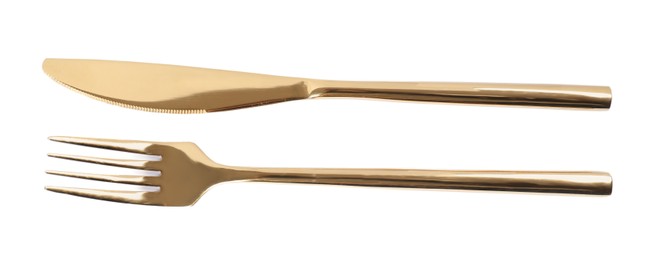 Photo of New shiny golden fork and knife on white background, top view