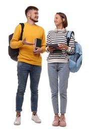 Photo of Young students with backpacks, books and tablet on white background