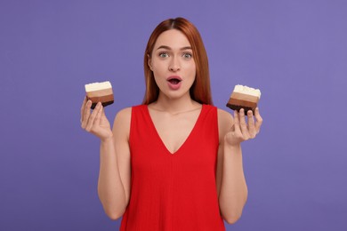 Emotional young woman with pieces of tasty cake on purple background