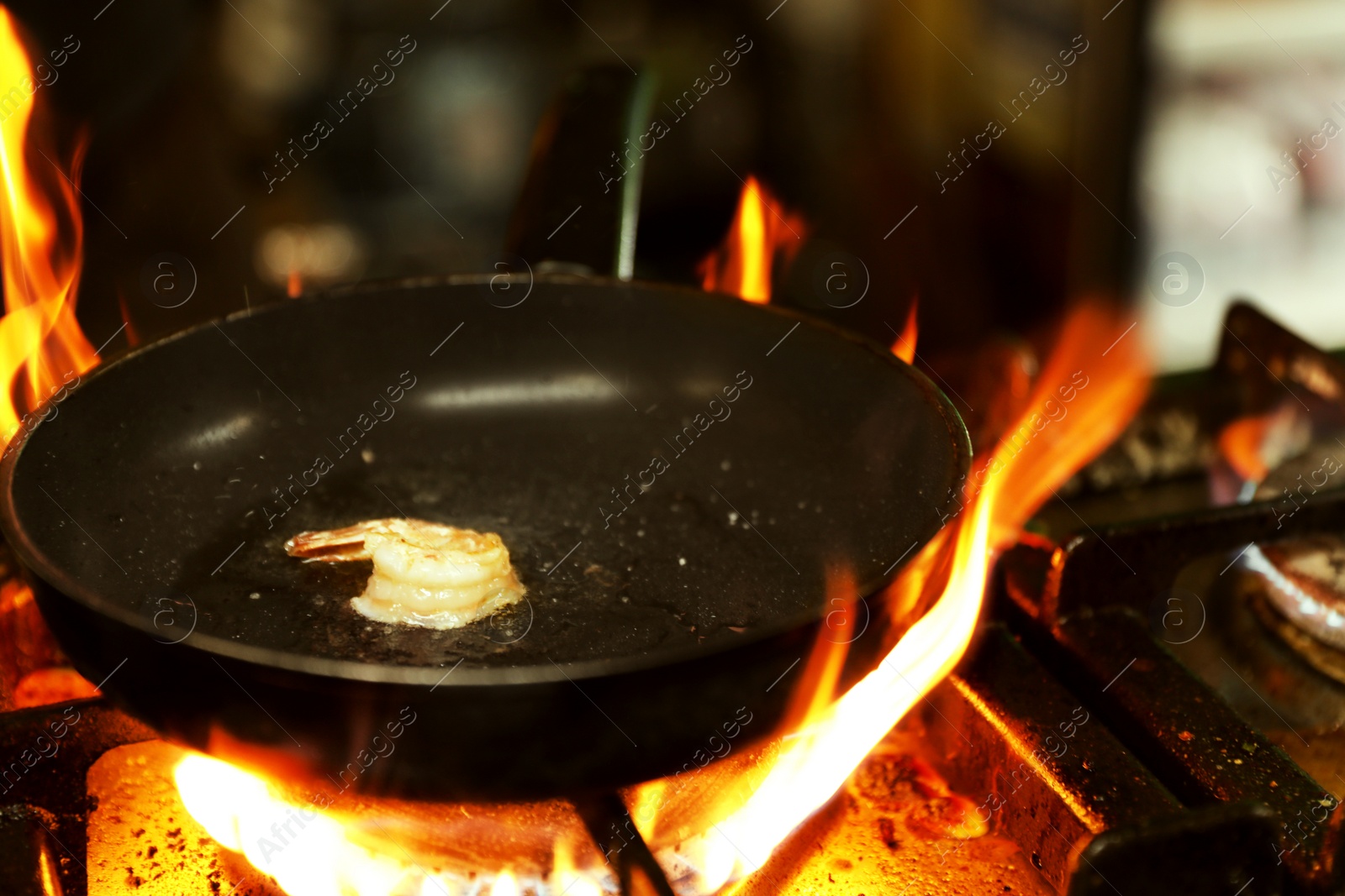 Photo of Cooking delicious shrimp with butter and spices on frying pan