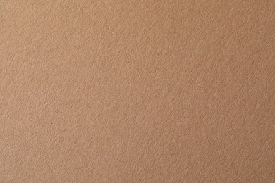 Photo of Texture of kraft paper sheet as background, closeup