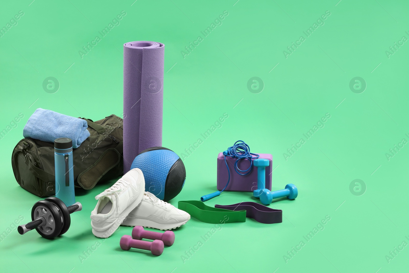 Photo of Many different sports equipment on green background, space for text