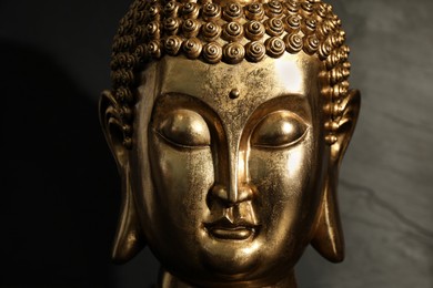 Photo of Buddha statue on dark background, closeup view