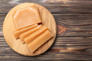 Tasty sweet quince paste on wooden table, top view. Space for text