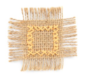 Photo of Piece of burlap fabric with yellow cross stitches isolated on white, top view