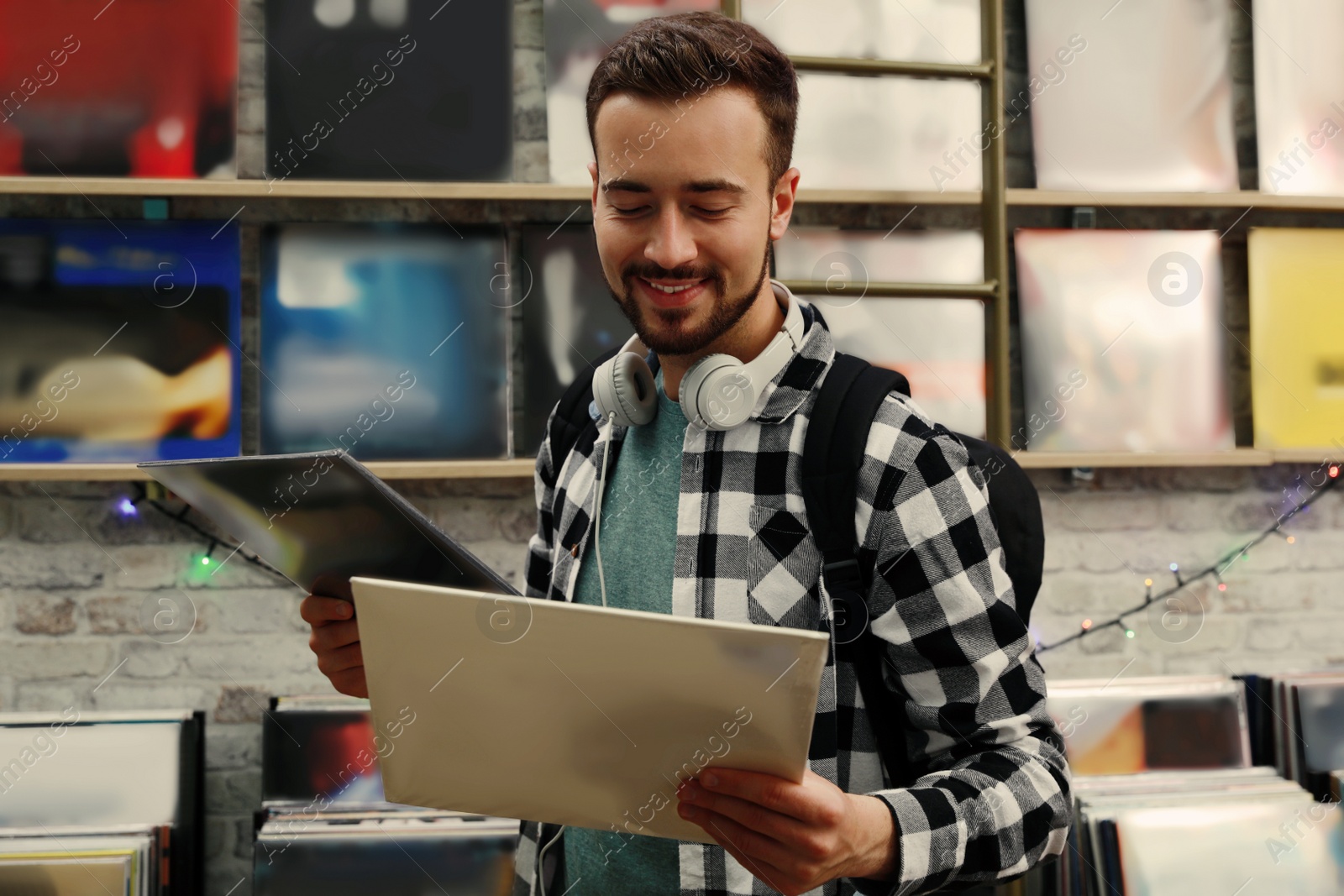 Image of Young man with vinyl records in store