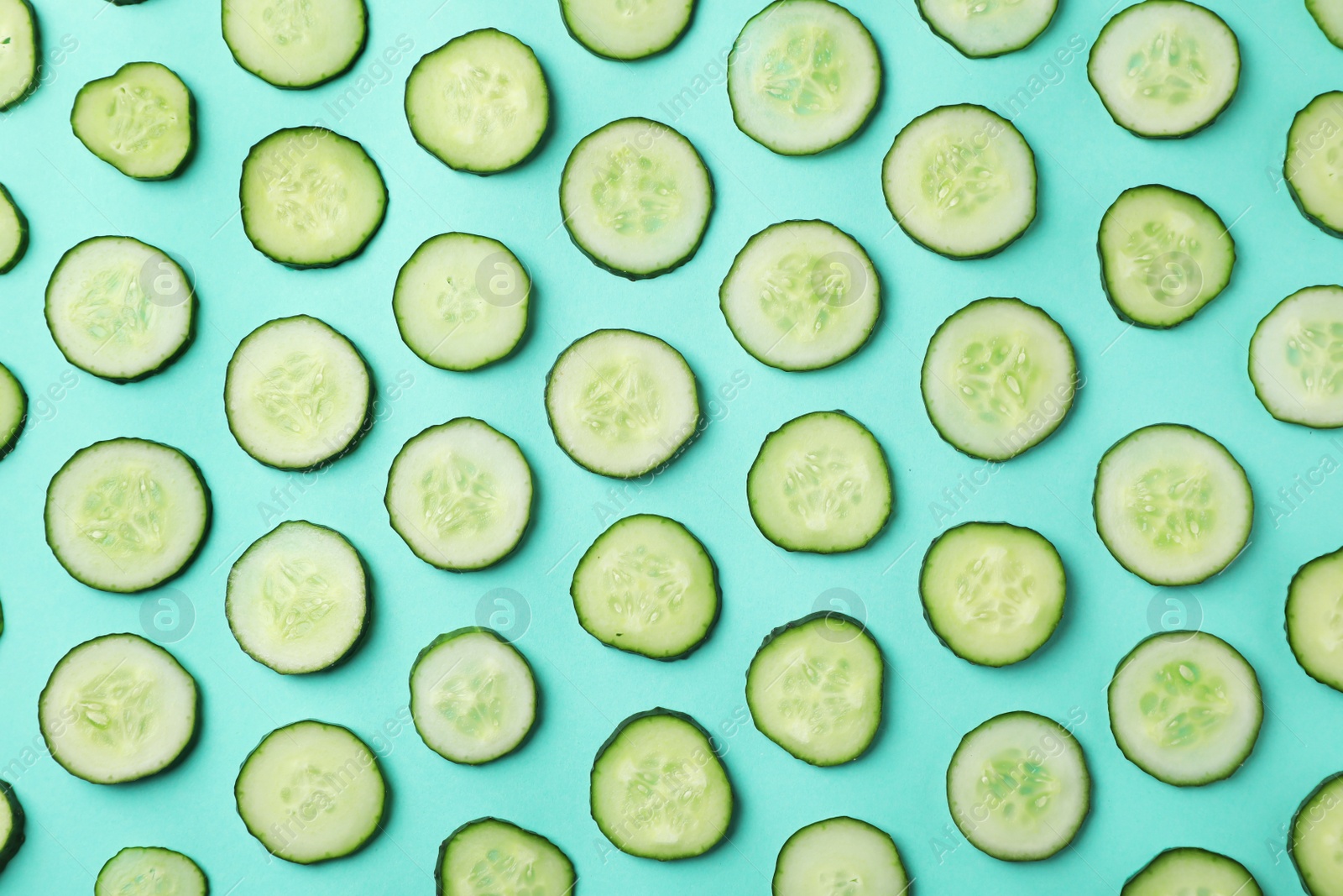 Photo of Flat lay composition with slices of cucumber on color background