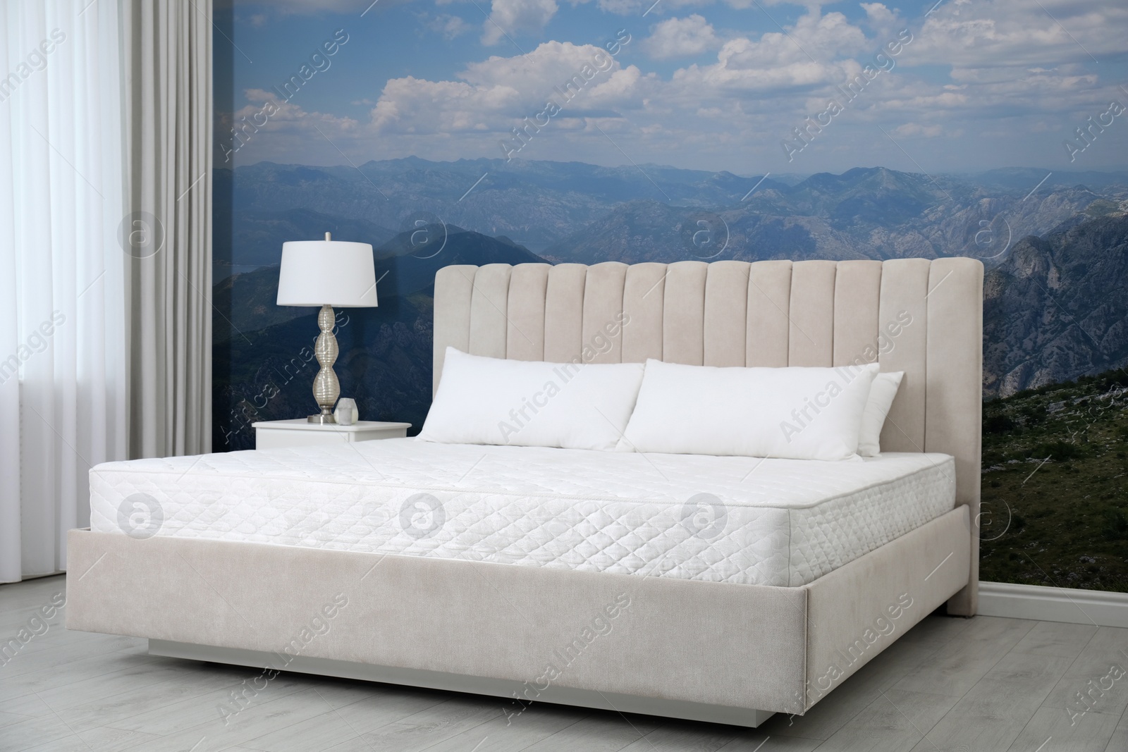 Image of Stylish interior with large bed and mountain landscape wallpapers