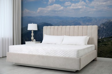 Image of Stylish interior with large bed and mountain landscape wallpapers