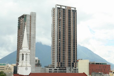 Beautiful view of different buildings in city and mountains