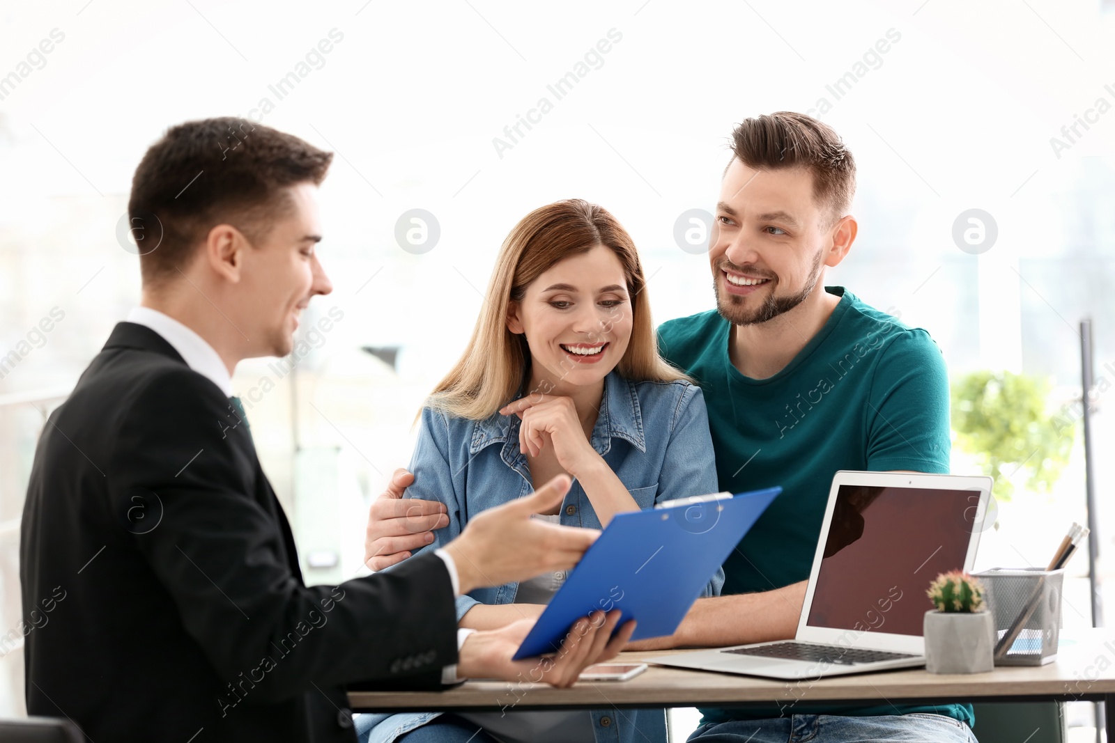 Photo of Young couple meeting with consultant in office