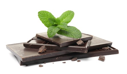 Tasty dark chocolate pieces with mint on white background