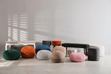 Many stylish different poufs and benches in room. Home design