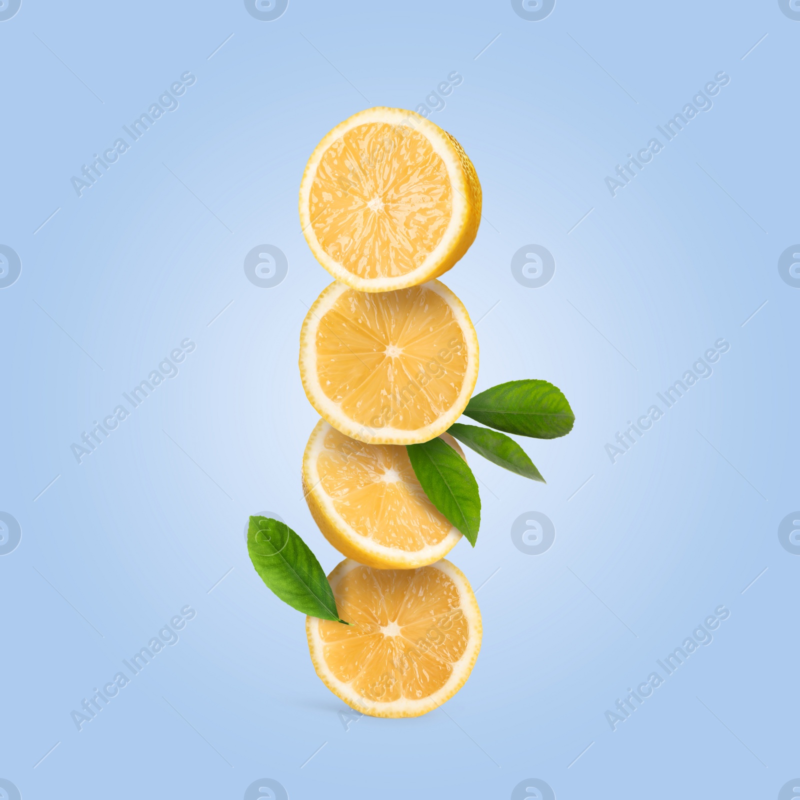 Image of Stack of cut fresh lemons with green leaves on pastel light blue background