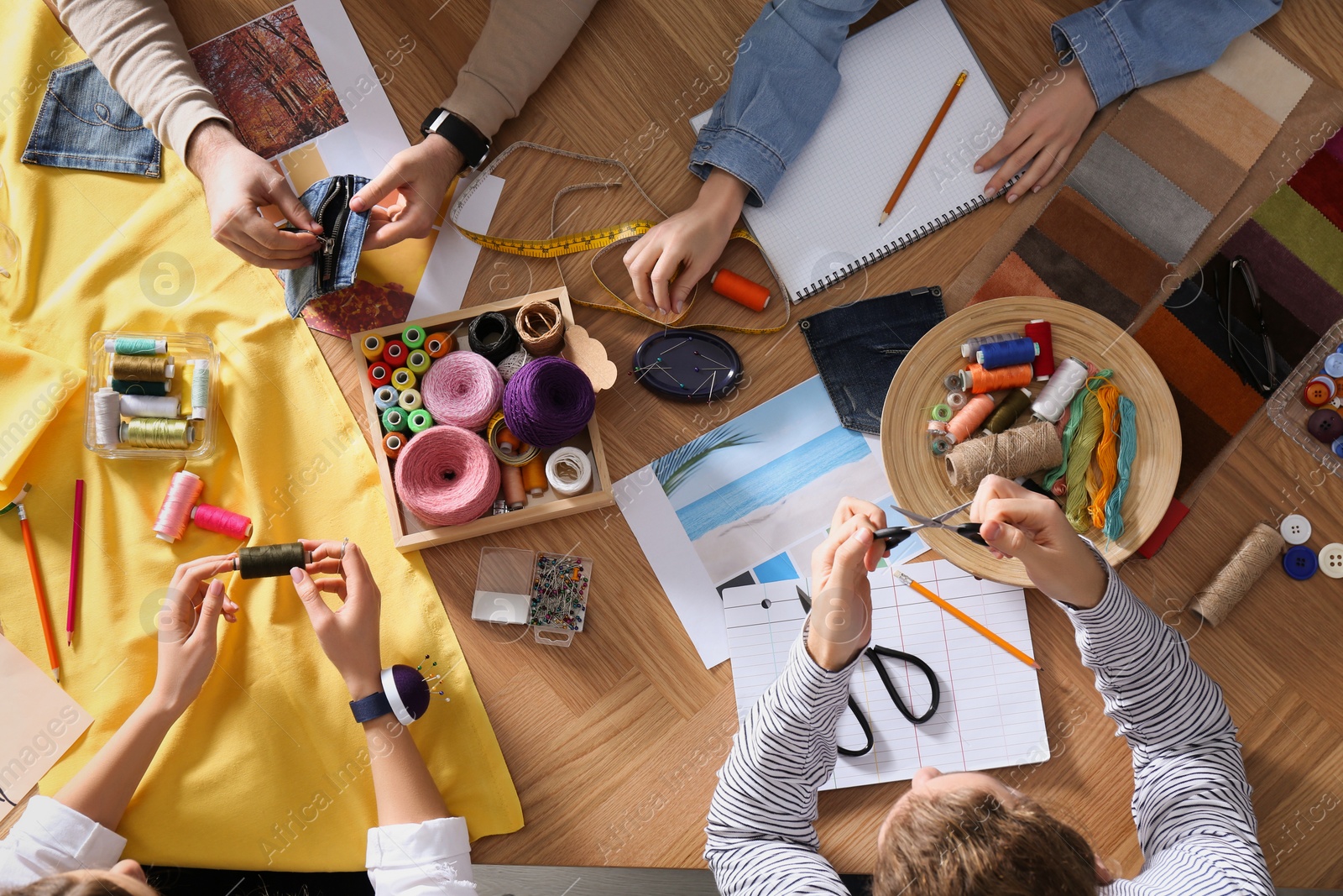 Photo of Fashion designer creating new clothes in studio, top view