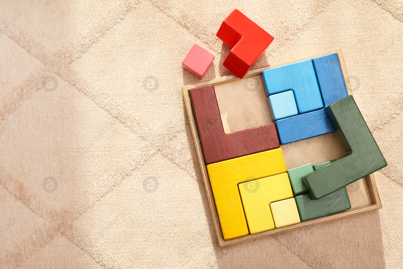 Photo of Set of wooden blocks on beige carpet, flat lay and space for text. Montessori toy