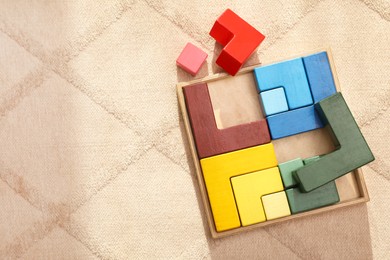Set of wooden blocks on beige carpet, flat lay and space for text. Montessori toy