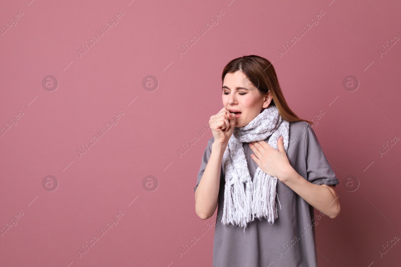 Photo of Woman coughing on color background