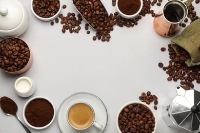 Frame of coffee grounds and roasted beans on white background, flat lay. Space for text