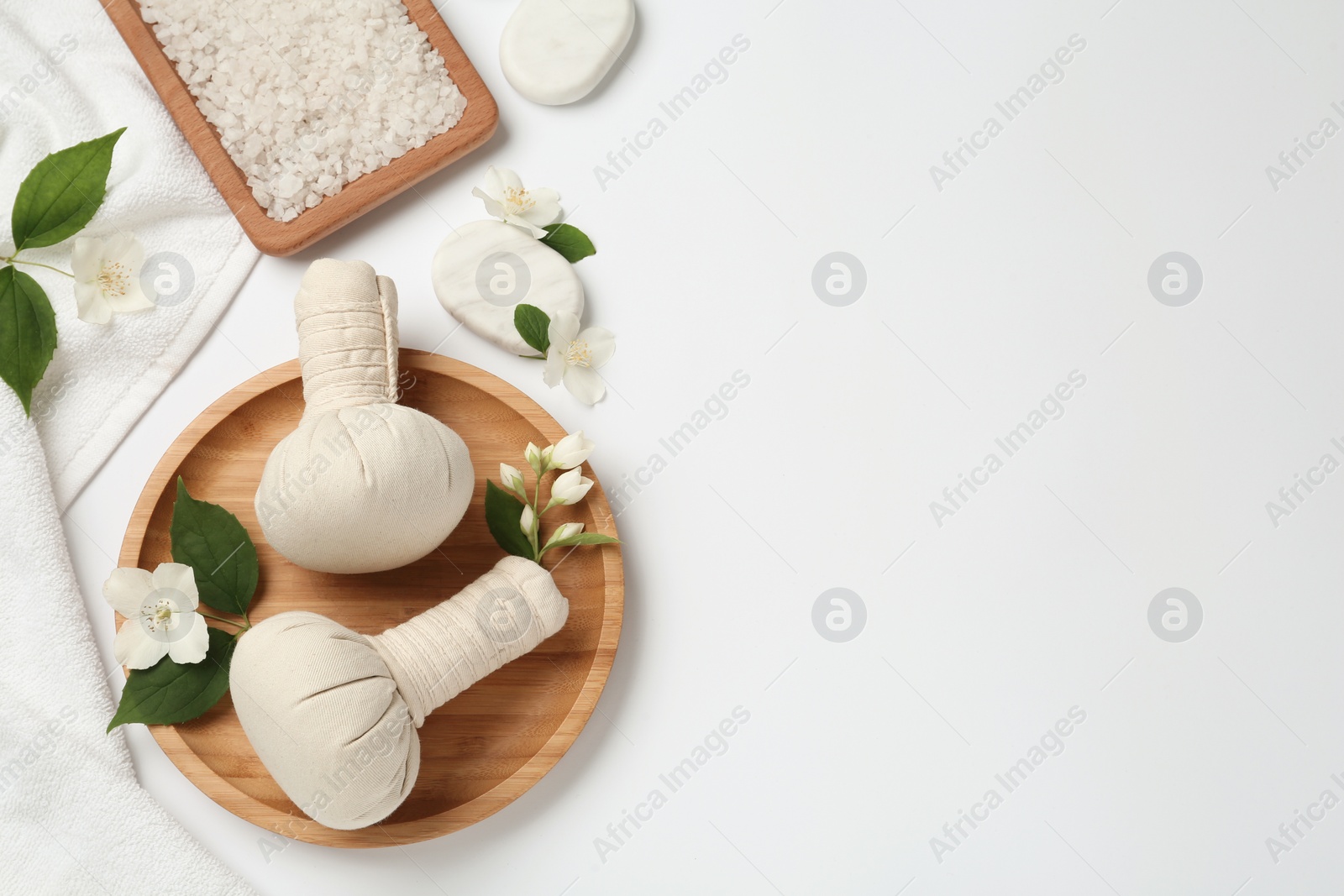 Photo of Flat lay composition with spa stones and beautiful jasmine flowers on white background. Space for text