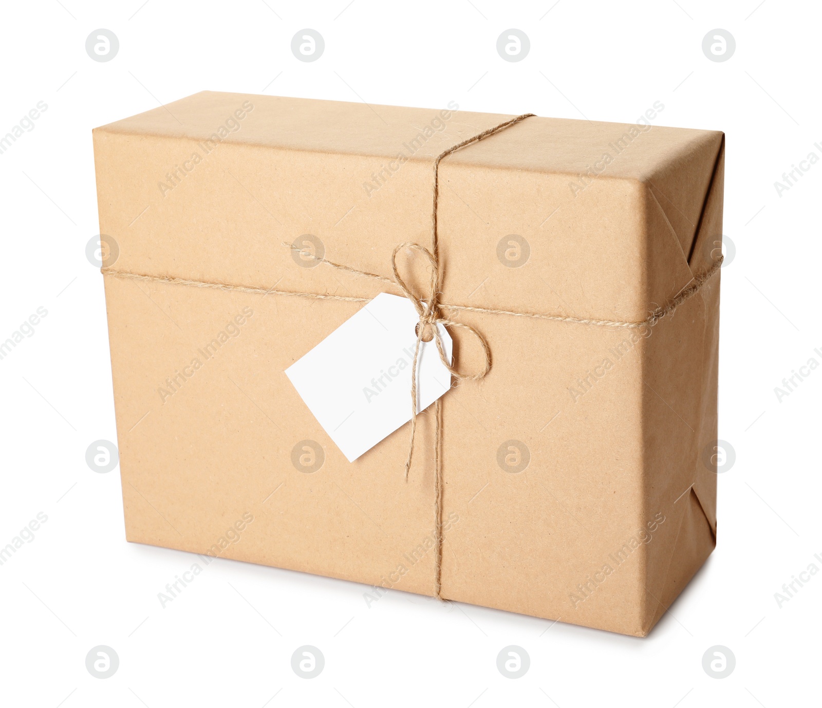 Photo of Gift box wrapped in kraft paper with bow and tag isolated on white